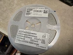 Reel Of 2000 Kyocera Multilayer Ceramic Capacitors 12103C106KAT2A. Fixed Price $200.00.